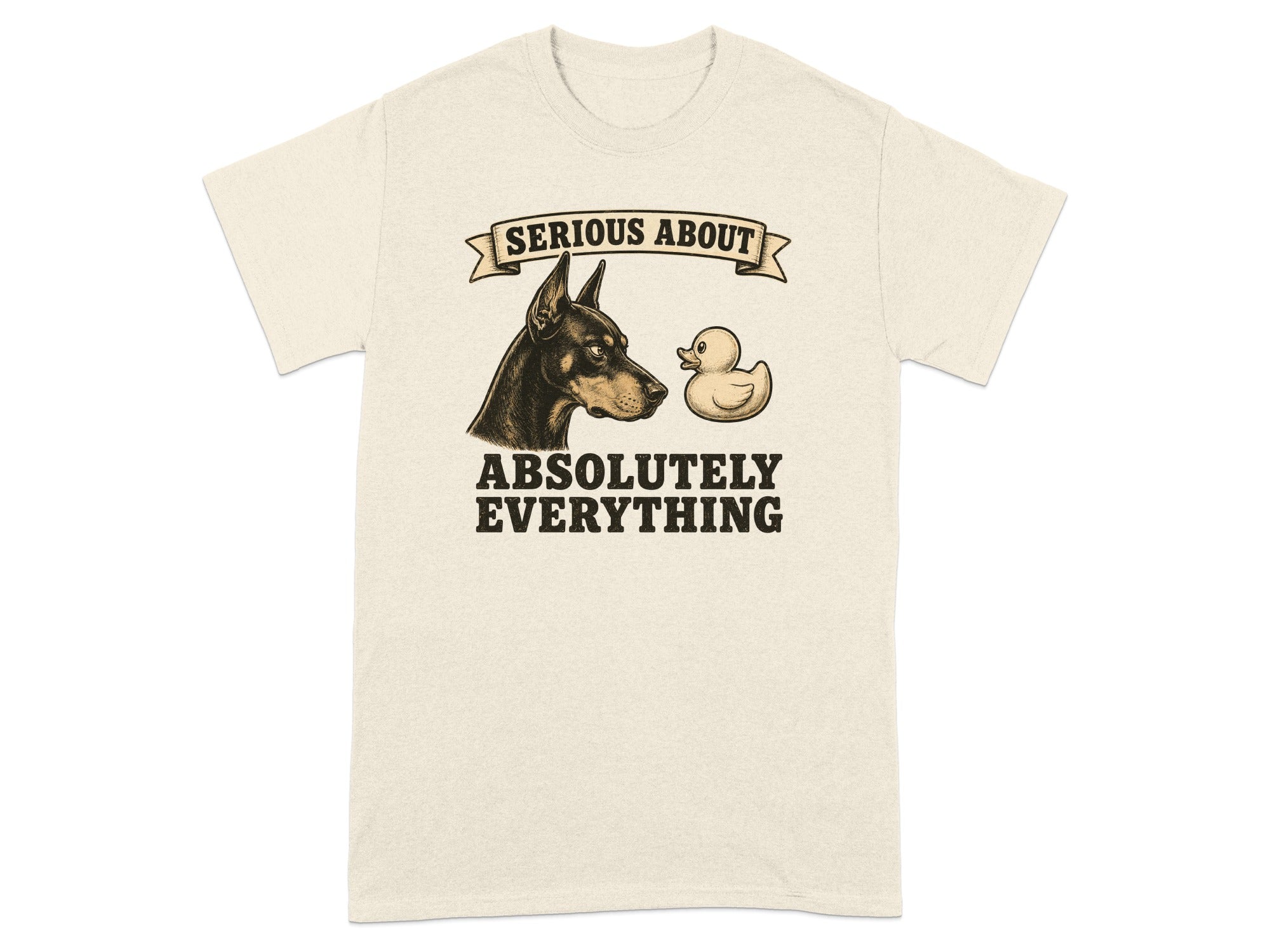 Cream t-shirt with Doberman and rubber duck graphic and text "SERIOUS ABOUT ABSOLUTELY EVERYTHING".