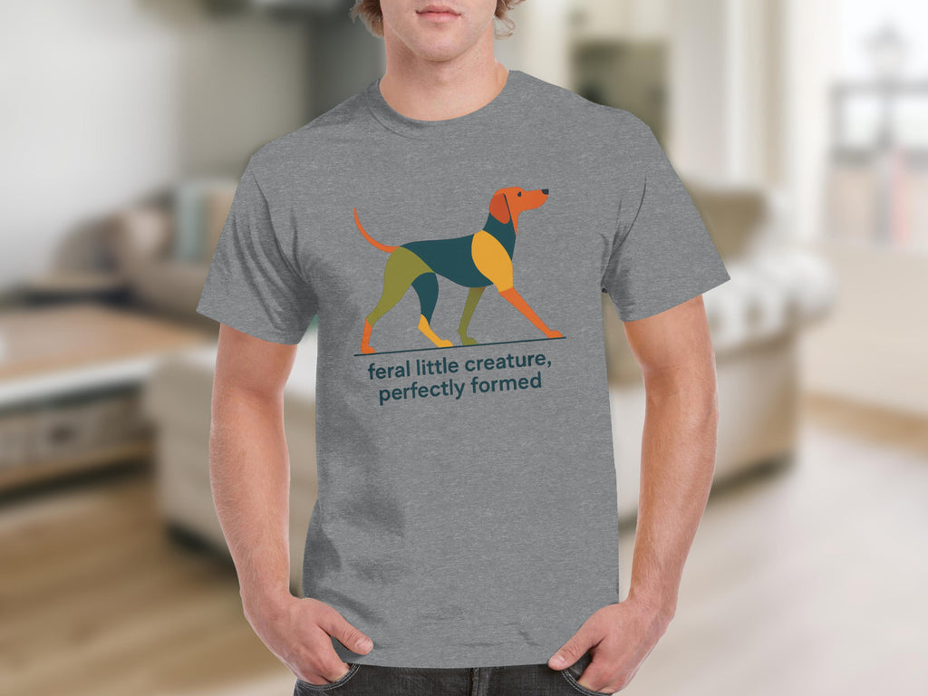 Grey t-shirt with a geometric dog graphic and text "feral little creature, perfectly formed".