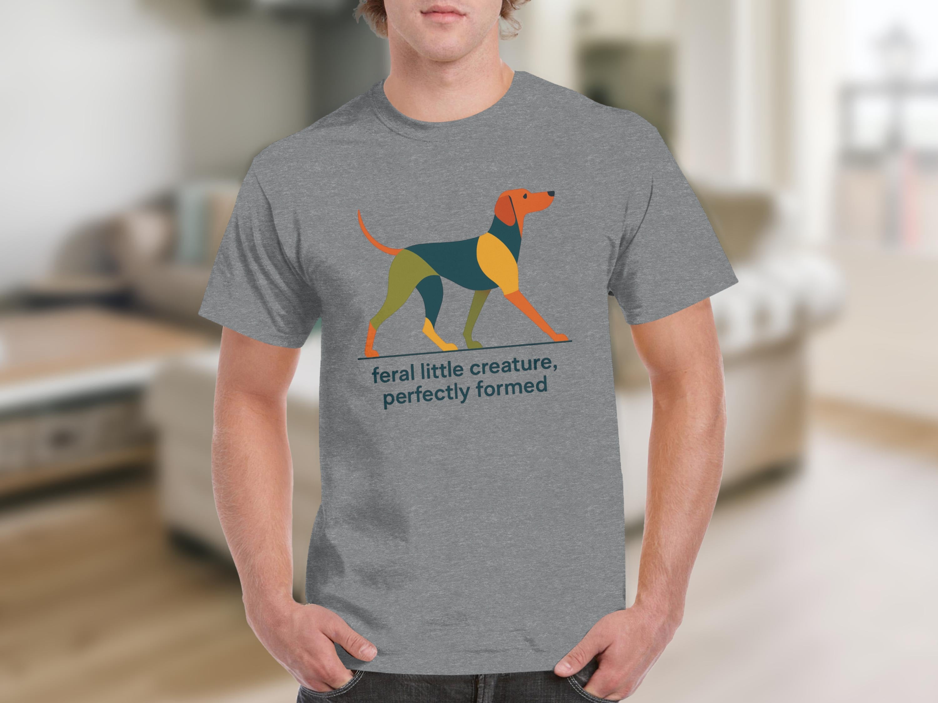 Grey t-shirt with a geometric dog graphic and text "feral little creature, perfectly formed".