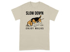 Beagle dog with "SLOW DOWN ENJOY WALKS" text on tan t-shirt.