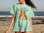 Light green t-shirt with a dog portrait and "Anxiety with Excellent Hair" text.