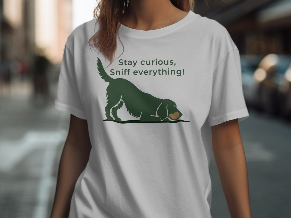 Green dog graphic with "Stay curious, Sniff everything!" text on white t-shirt.