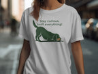 Green dog graphic with "Stay curious, Sniff everything!" text on white t-shirt.