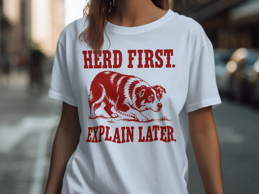 White t-shirt with red text and border collie graphic: "HERD FIRST. EXPLAIN LATER."