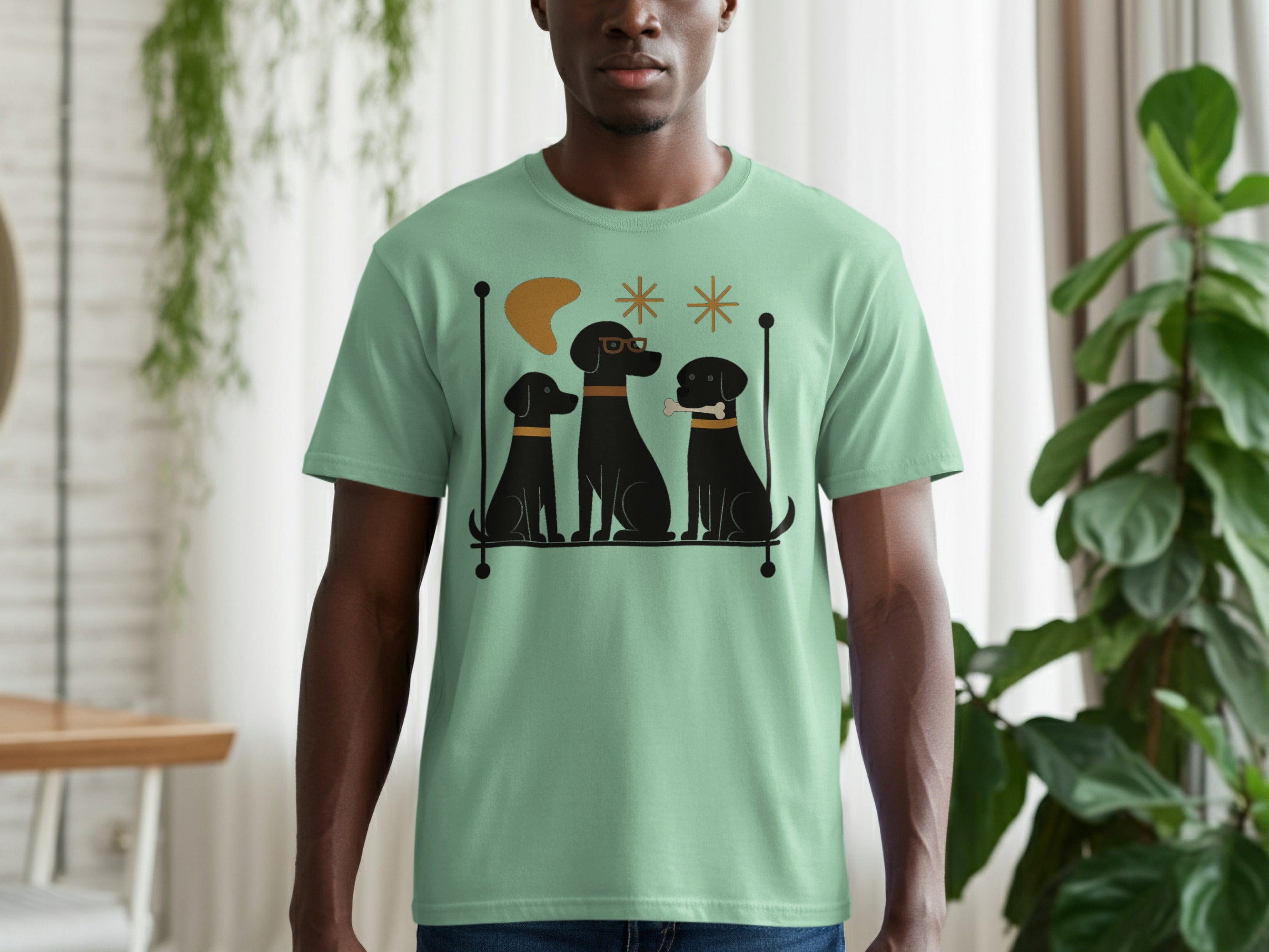 T-shirt with illustration of three black dogs in a row.