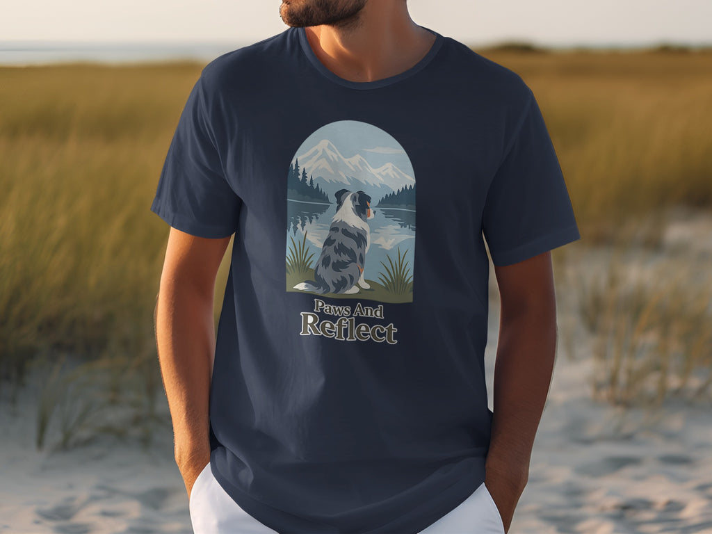 Navy t-shirt with a scenic mountain, lake, and dog graphic and text "Paws And Reflect."