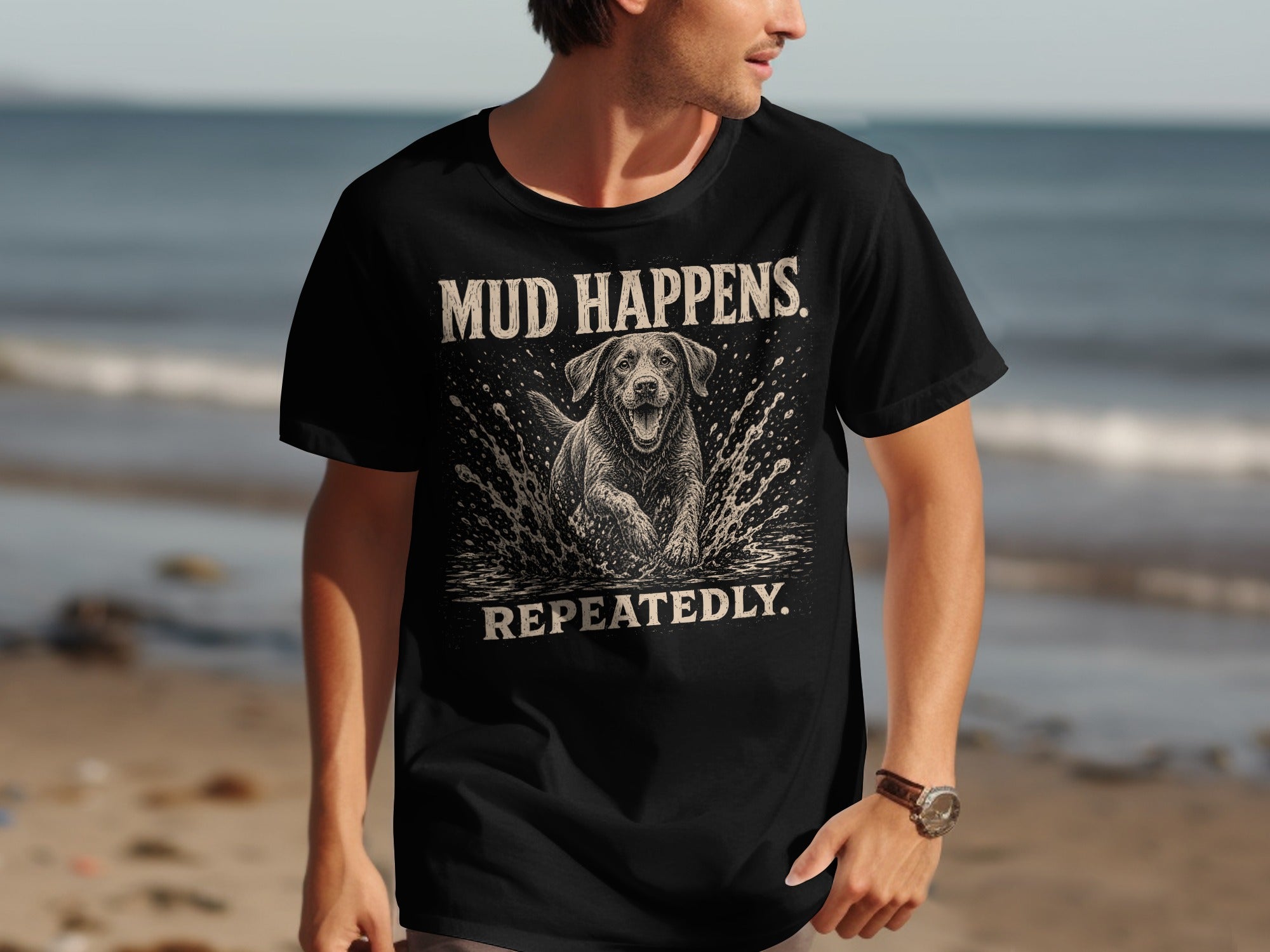 Black t-shirt with white text "MUD HAPPENS REPEATEDLY" and a dog splashing water.
