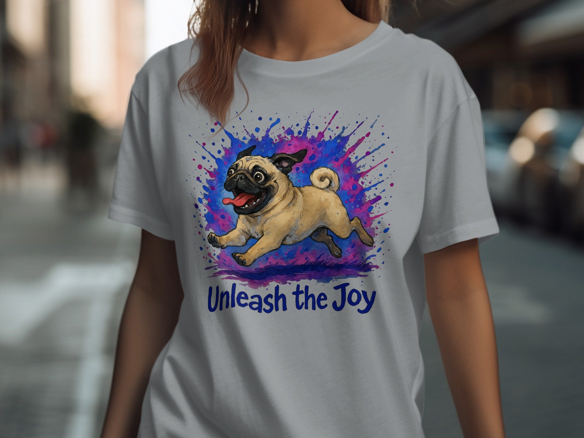 Gray t-shirt with a pug running amidst a colorful paint splatter and the text "Unleash the Joy".