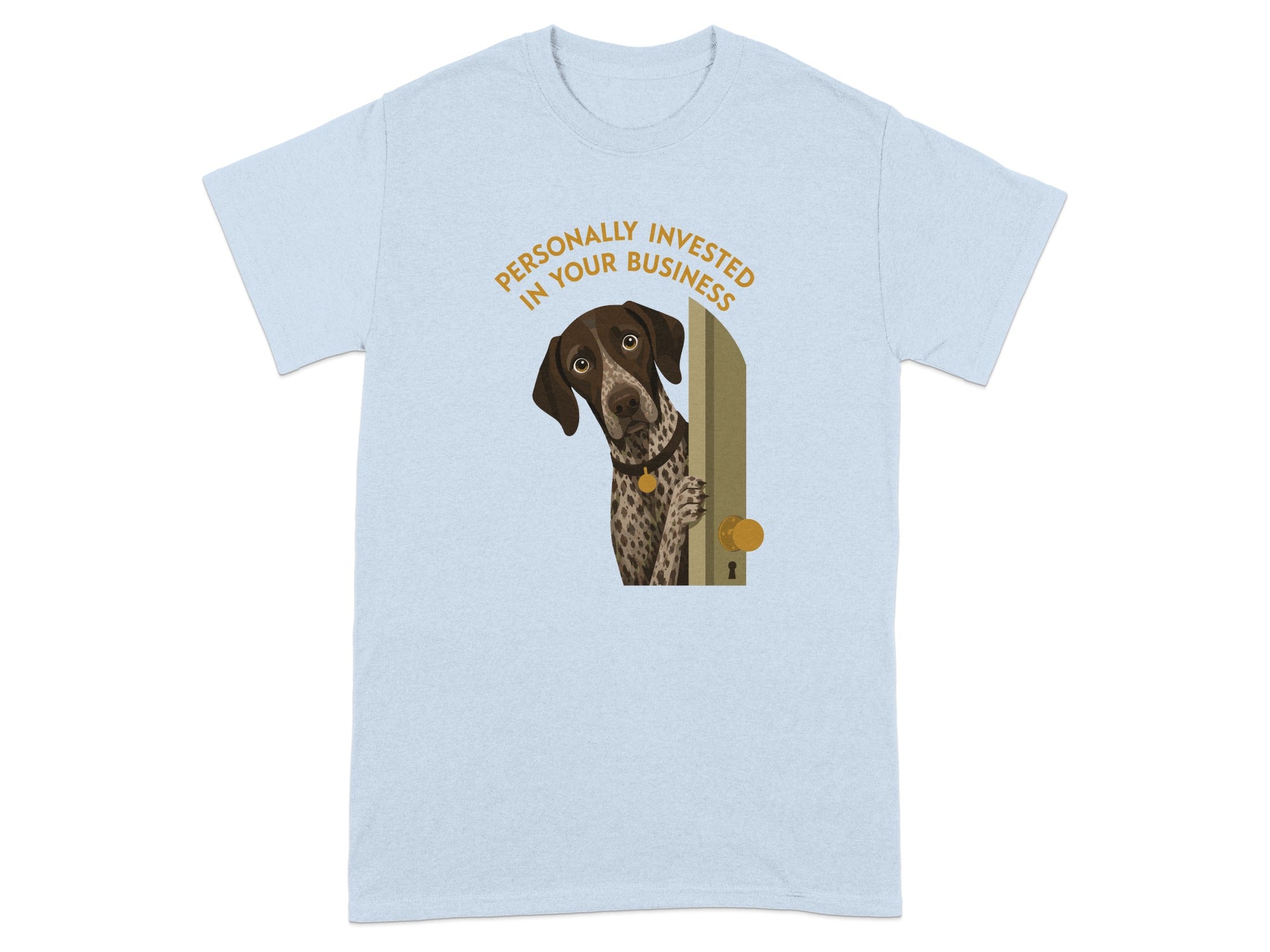 Brown and white dog peeking through a doorway on a light blue t-shirt.