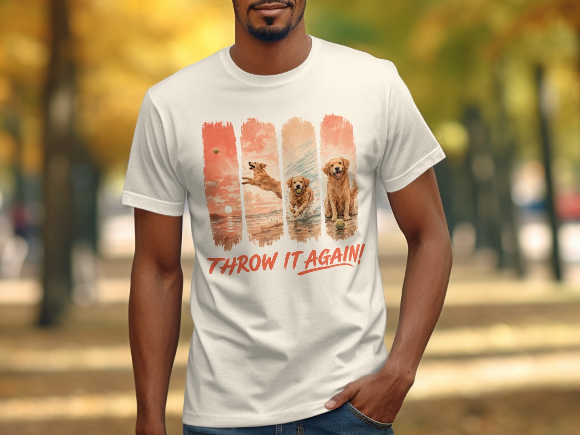 White t-shirt with golden retrievers playing fetch in four watercolor panels and text "THROW IT AGAIN!".