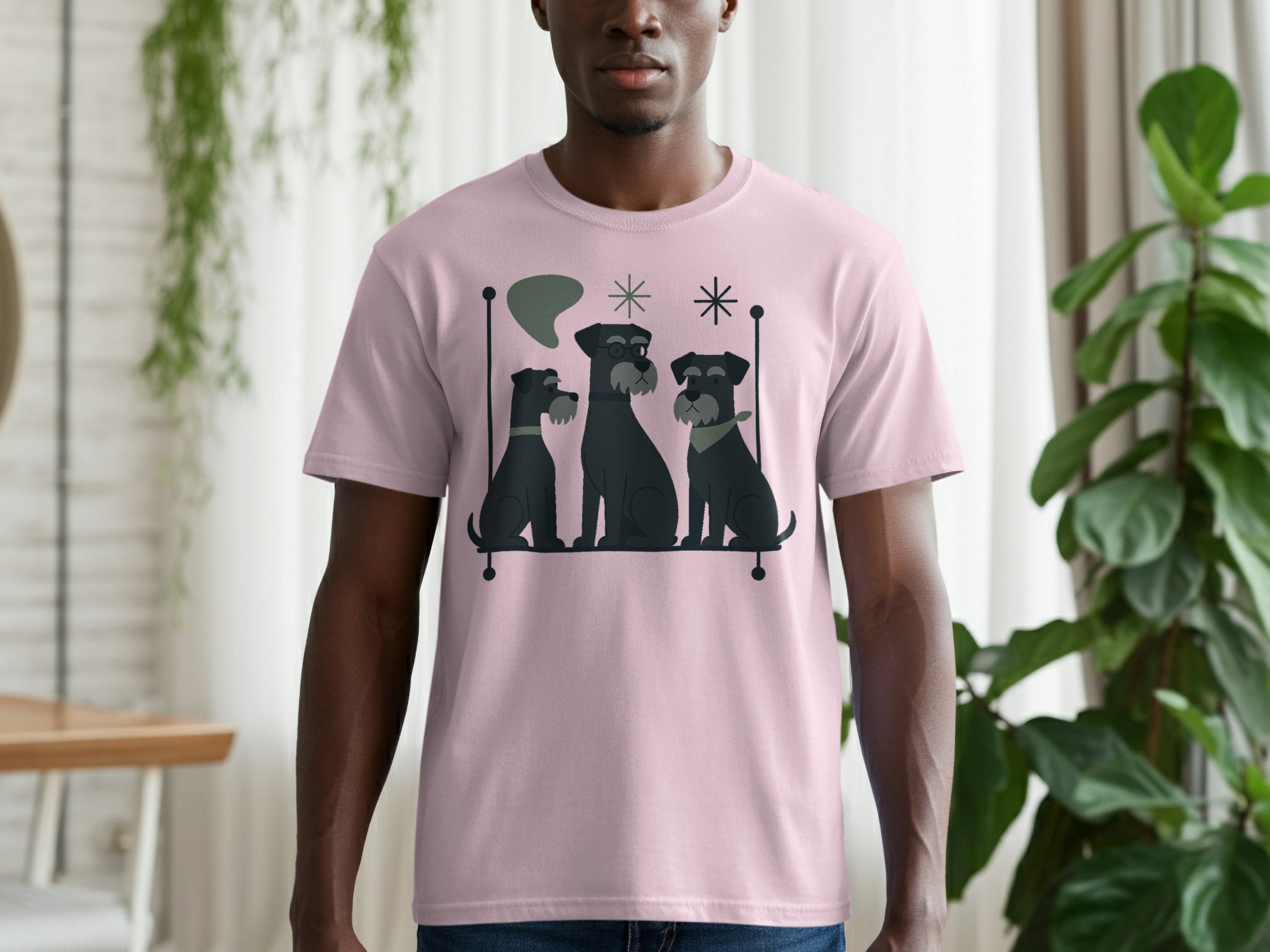 Pink t-shirt with a graphic of three black schnauzer dogs sitting and abstract mid-century modern shapes.