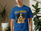 Blue t-shirt with a dog holding a tennis ball and text "Ball obsessed".