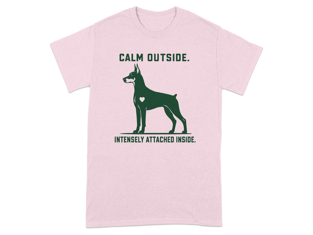 Pink t-shirt with Doberman silhouette and text "CALM OUTSIDE. INTENSELY ATTACHED INSIDE."