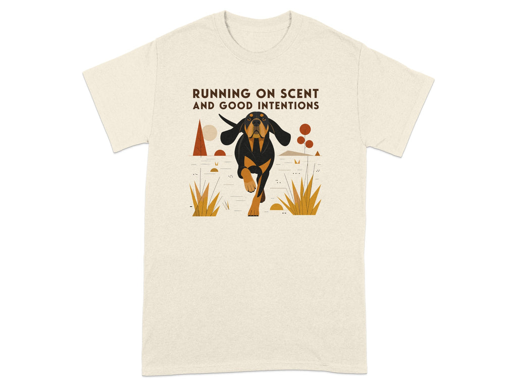 Cream t-shirt with illustration of a black and tan dog running, text reads "RUNNING ON SCENT AND GOOD INTENTIONS".