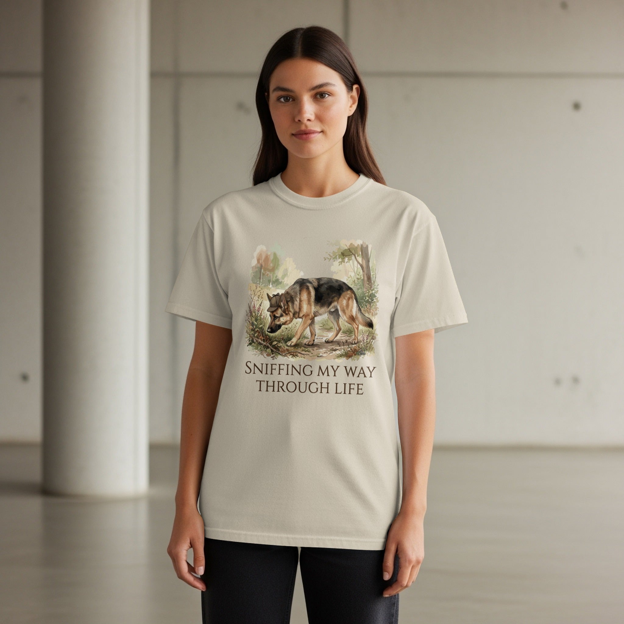 Woman wearing light beige t-shirt with wolf sniffing in a forest design.
