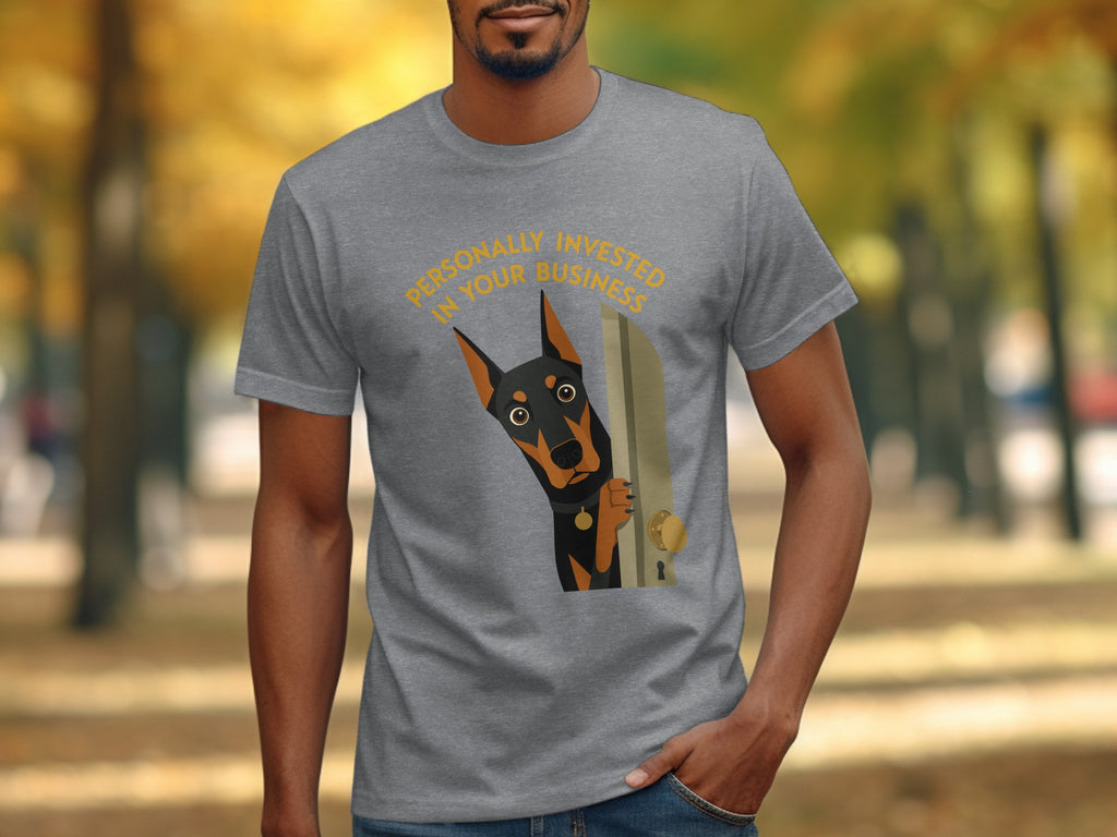 Grey t-shirt with a curious Doberman peeking through a door, text "Personally Invested in Your Business".