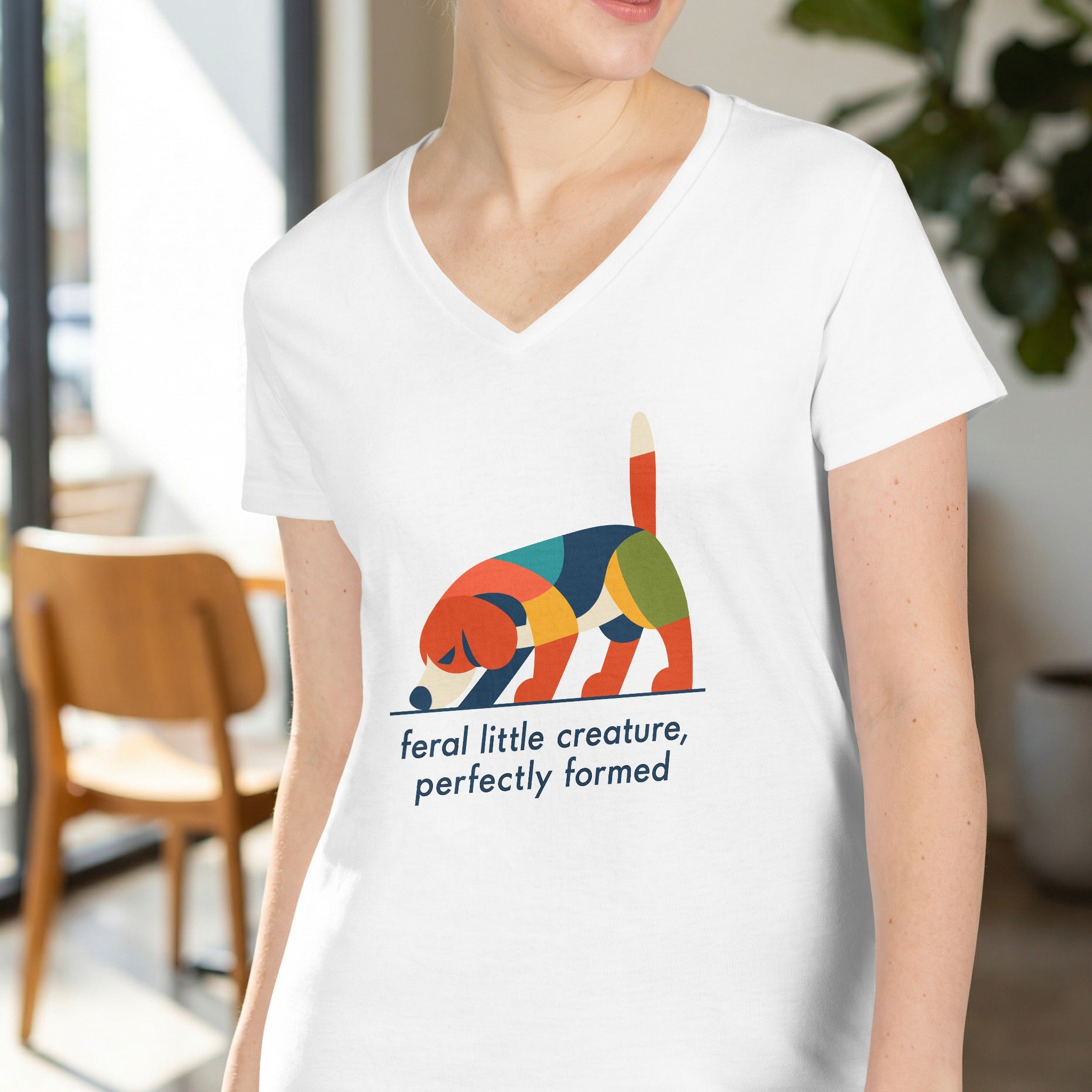 White t-shirt with abstract dog graphic and text "feral little creature, perfectly formed".
