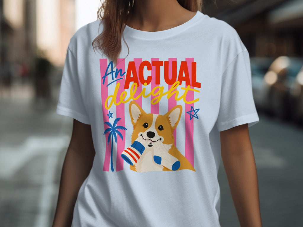 White t-shirt with a cartoon corgi holding a striped flag and stars.