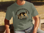 Olive green t-shirt with a German Shepherd sniffing the ground and text "EVERY WALK IS AN INVESTIGATION".