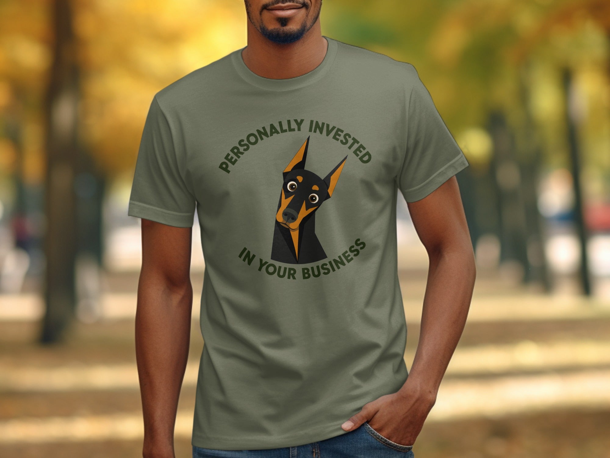 Man wearing a green t-shirt with a Doberman dog graphic and text.