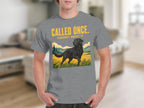 Black Labrador Retriever running in a field with "Called Once. Thought About It." text.