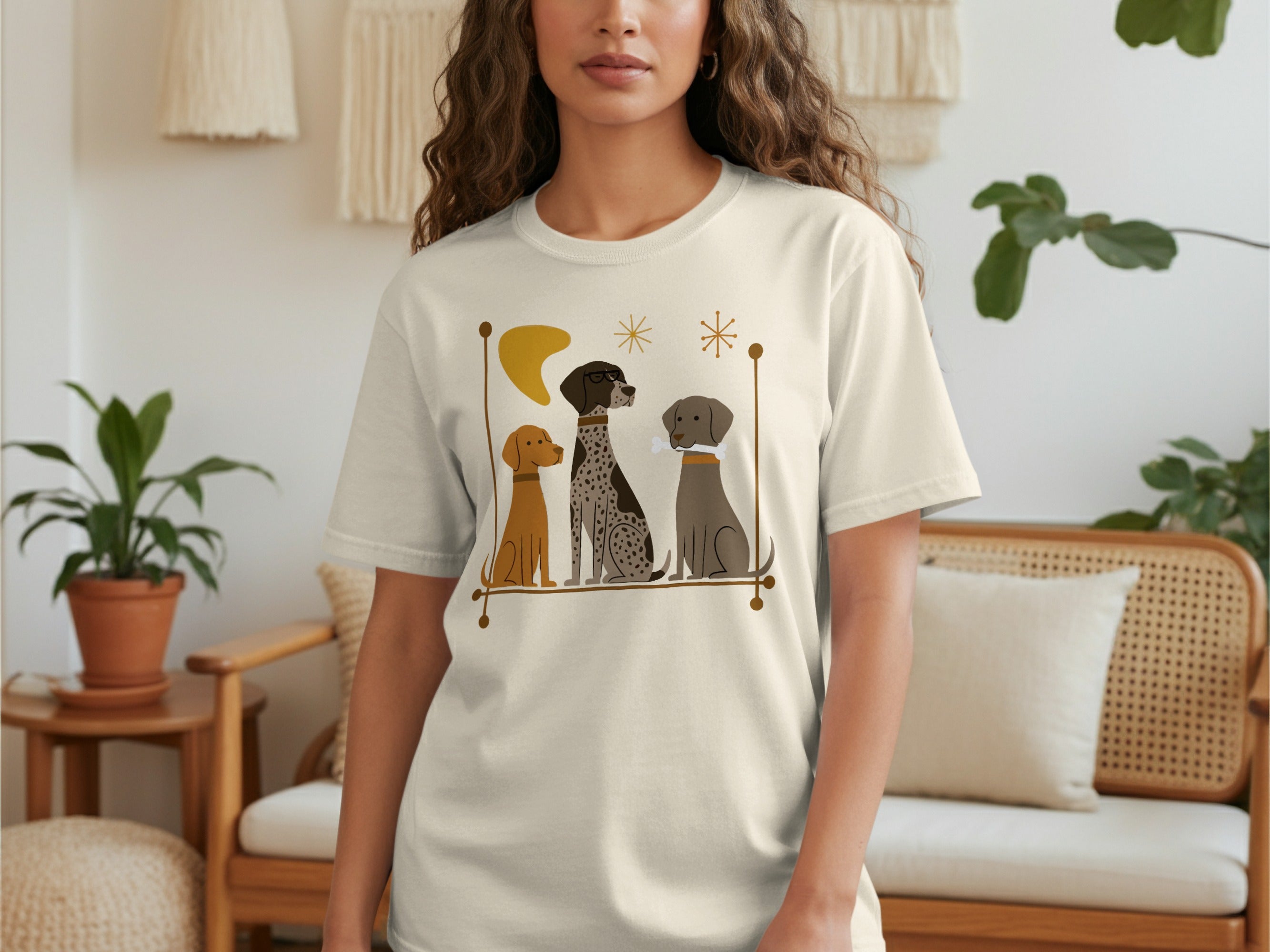 T-shirt with a graphic of three stylized dogs sitting in a line.