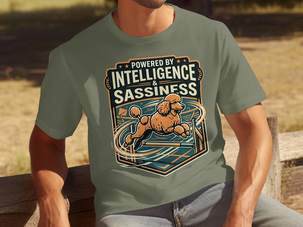 T-shirt graphic of a poodle jumping over an obstacle, with text "Powered by Intelligence & Sassiness".