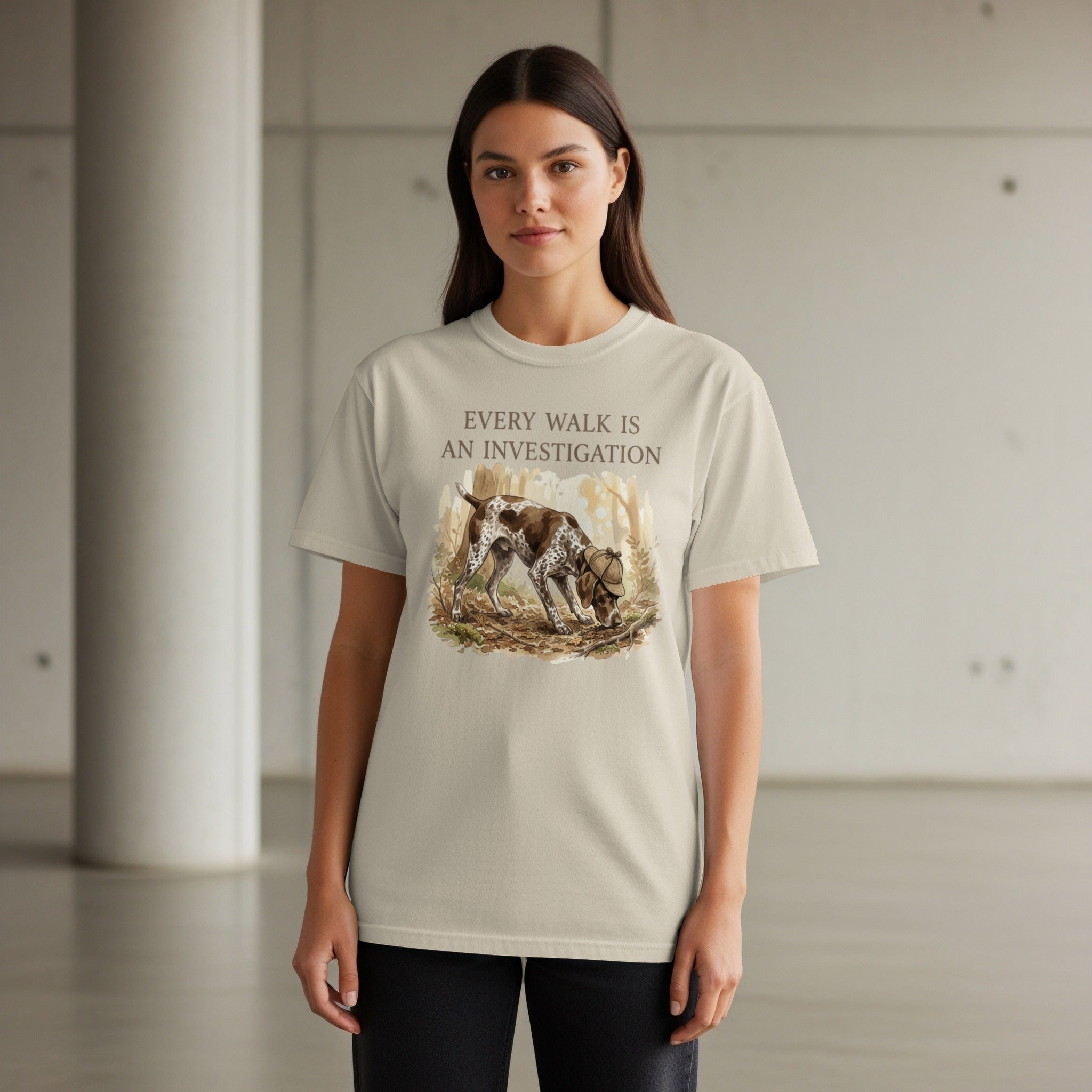 T-shirt with a German Shorthaired Pointer investigating a wooded area.