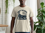 Light tan t-shirt with graphic of a dog sniffing and text "TRUST THE NOSE".
