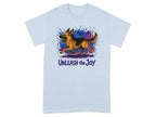 Light blue t-shirt with a watercolor German Shepherd and the text "Unleash the Joy".
