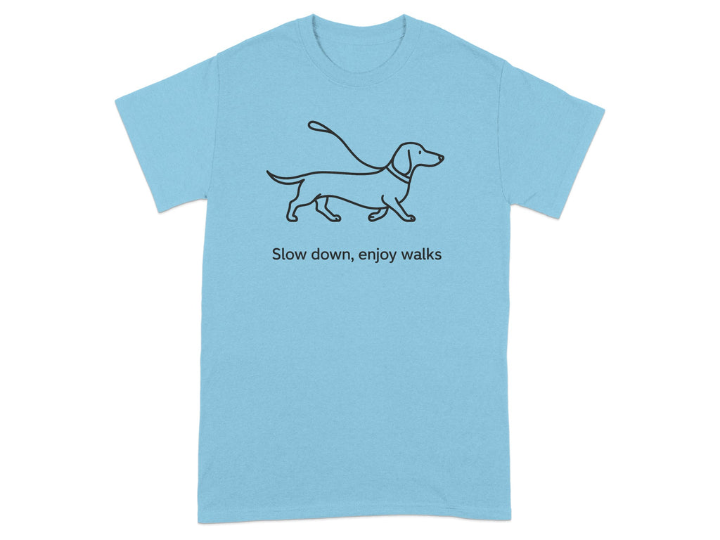 Light blue t-shirt with dachshund illustration and text "Slow down, enjoy walks".