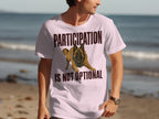 Light pink t-shirt with a German Shepherd and text "PARTICIPATION IS NOT OPTIONAL".