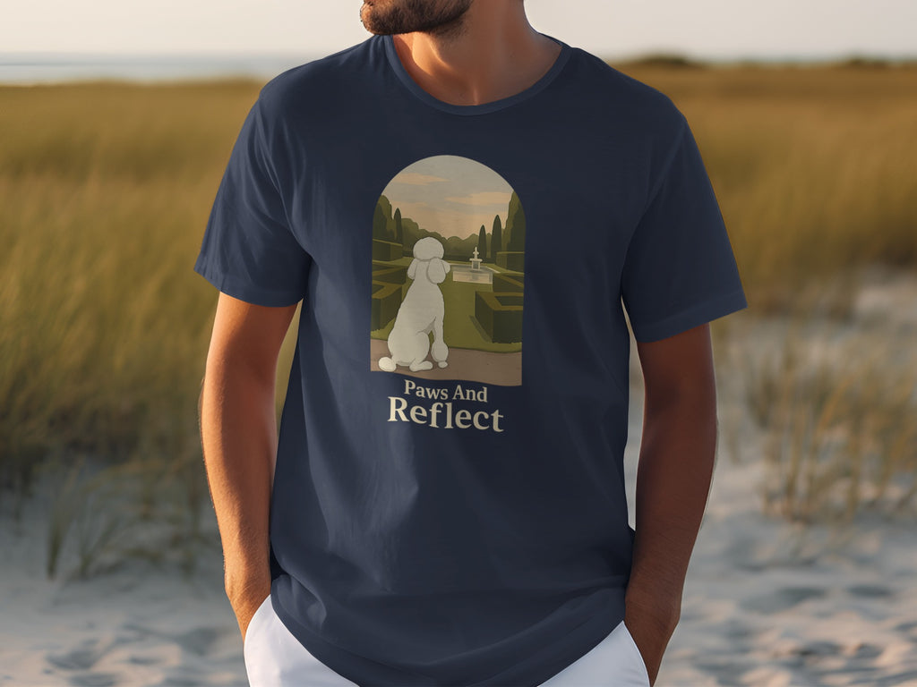 Navy t-shirt with a white poodle looking at a garden fountain, "Paws And Reflect".
