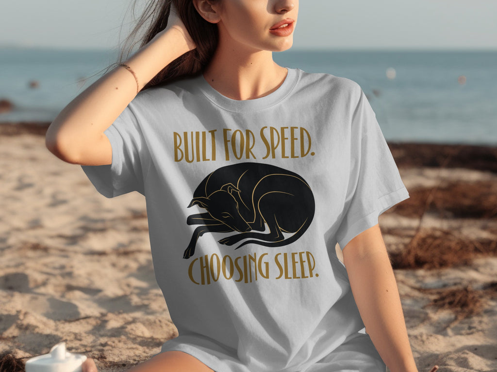 Woman wearing a grey t-shirt with a sleeping black dog graphic and text.