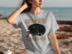 Woman wearing a grey t-shirt with a sleeping black dog graphic and text.