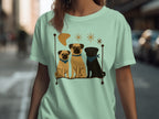 Three pugs, one wearing glasses, sit on a shelf with decorative stars and a crescent.