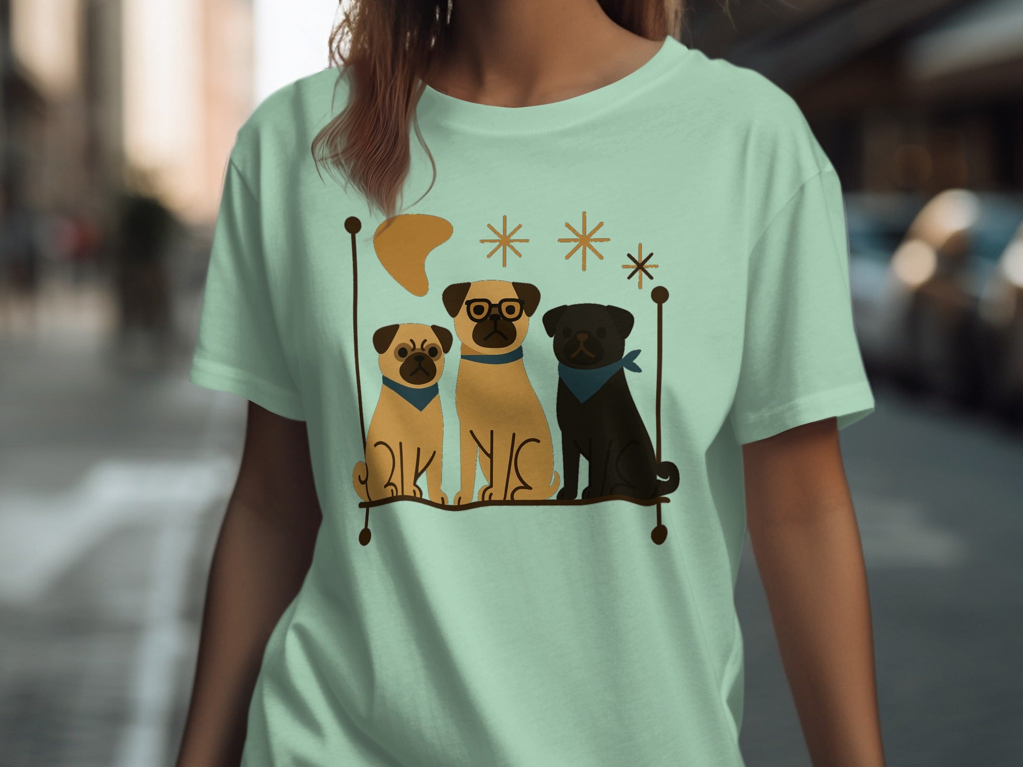 Three pugs, one wearing glasses, sit on a shelf with decorative stars and a crescent.