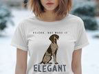 White t-shirt with dog illustration and text "VELCRO, BUT MAKE IT ELEGANT".