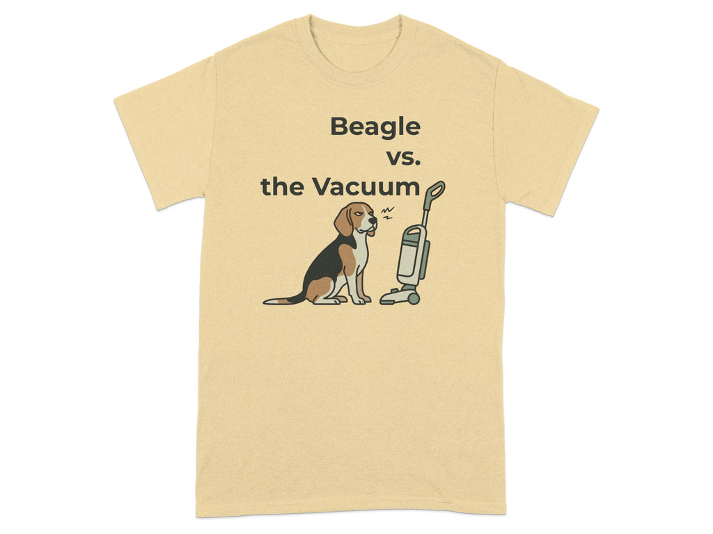 Beagle sits warily before a vacuum cleaner on a tan t-shirt.