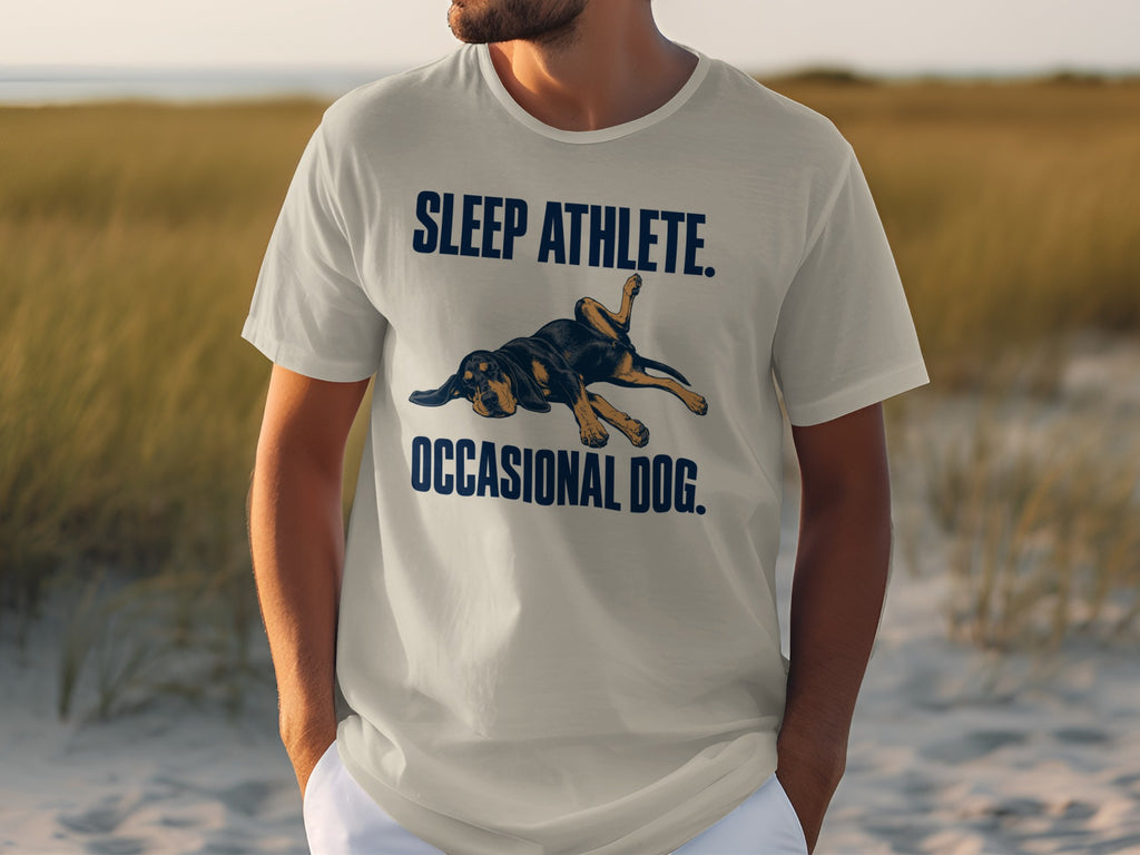 Light gray t-shirt with text "SLEEP ATHLETE. OCCASIONAL DOG." and a dog graphic.