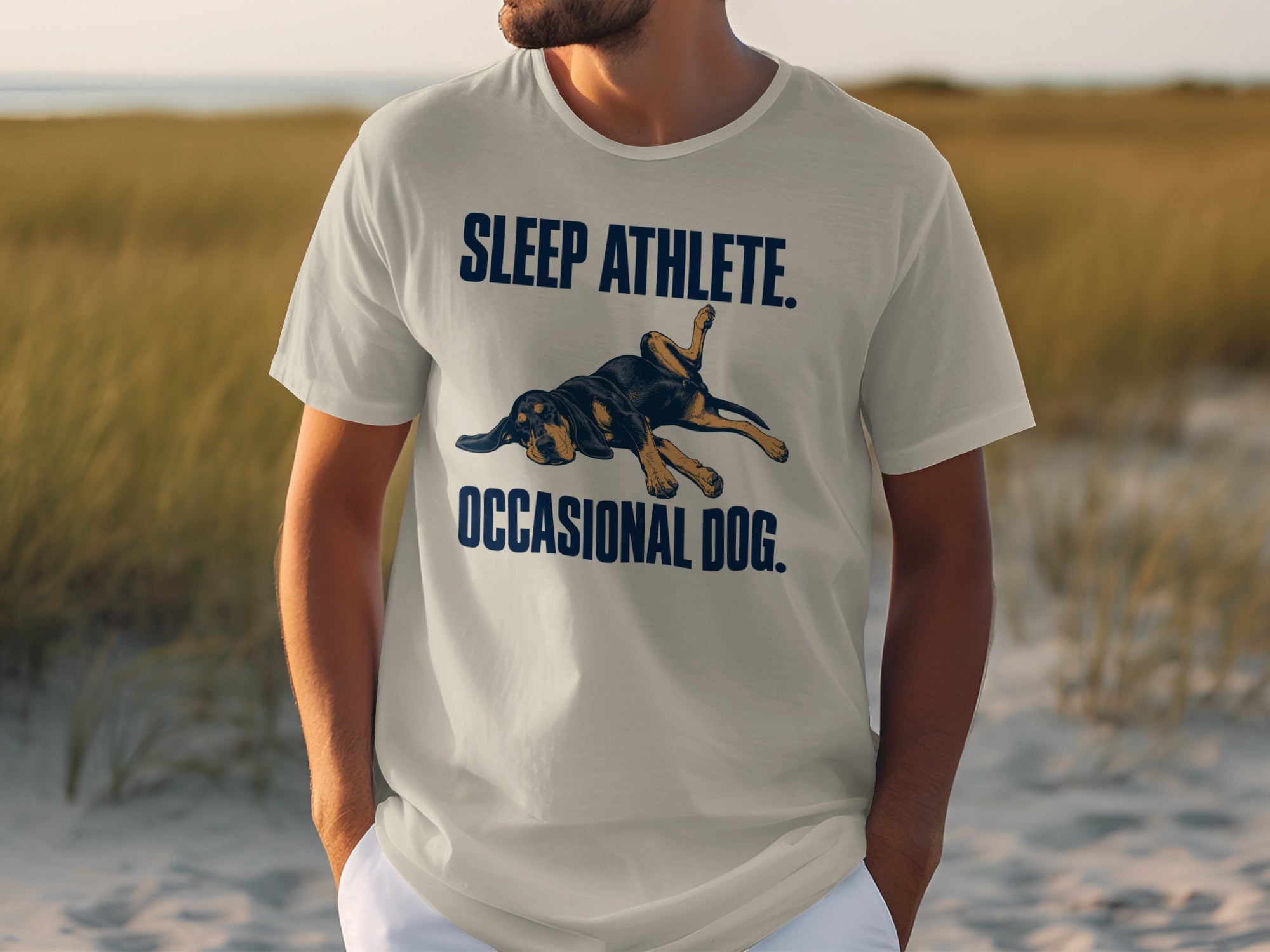 Light gray t-shirt with text "SLEEP ATHLETE. OCCASIONAL DOG." and a dog graphic.