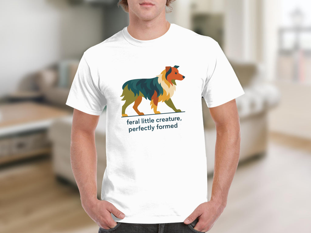 White t-shirt with abstract dog graphic and text "feral little creature, perfectly formed."