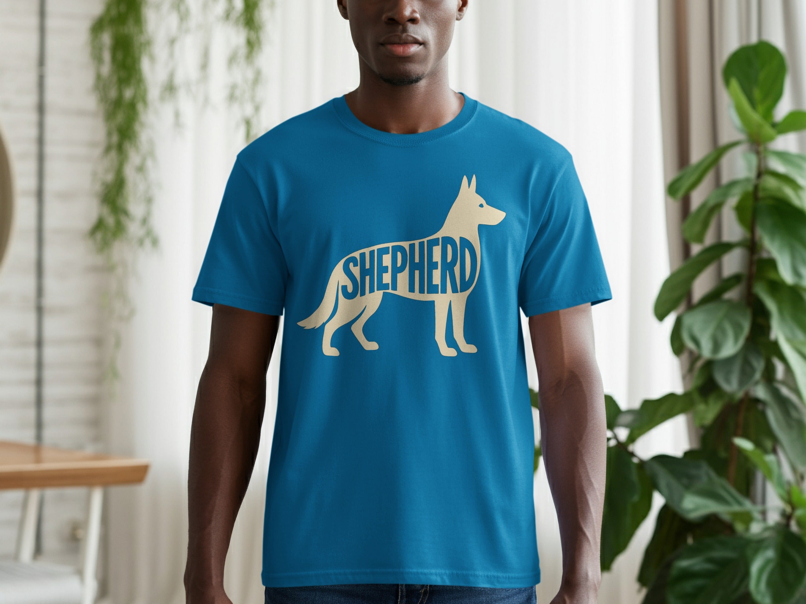 Blue t-shirt with a cream-colored German Shepherd silhouette graphic that spells "SHEPHERD"